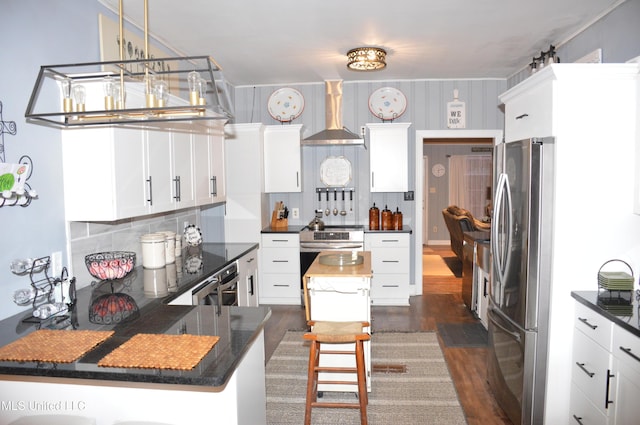 kitchen featuring a center island, white cabinets, wall chimney exhaust hood, stainless steel fridge, and dark hardwood / wood-style flooring