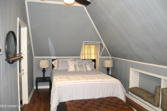 bedroom with dark hardwood / wood-style floors and lofted ceiling