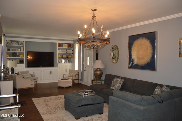 living room featuring built in features, dark hardwood / wood-style floors, an inviting chandelier, and crown molding