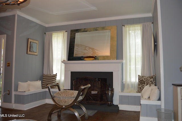 sitting room featuring a healthy amount of sunlight, dark hardwood / wood-style flooring, and ornamental molding