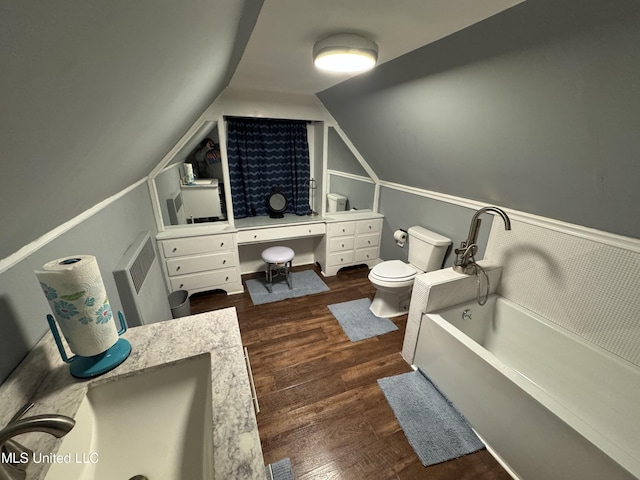 bathroom featuring hardwood / wood-style floors, vanity, toilet, and lofted ceiling