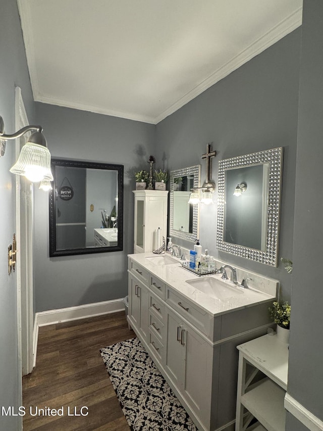 bathroom with vanity, wood-type flooring, and crown molding