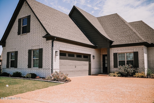 view of front of property with a front yard and a garage