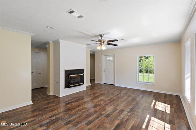 unfurnished living room with crown molding, ceiling fan, a fireplace, and dark hardwood / wood-style flooring