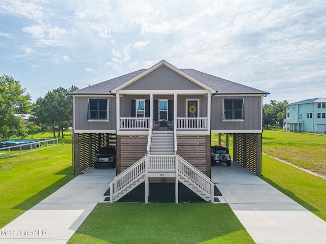 118 Sea Oaks Blvd, Long Beach, MS 39560 - raised beach house with driveway, roof with shingles, a carport, and a front yard