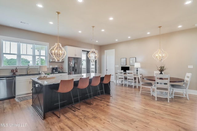 118 Sea Oaks Blvd, Long Beach, MS 39560 - kitchen with a chandelier, appliances with stainless steel finishes, a sink, a center island, and recessed lighting