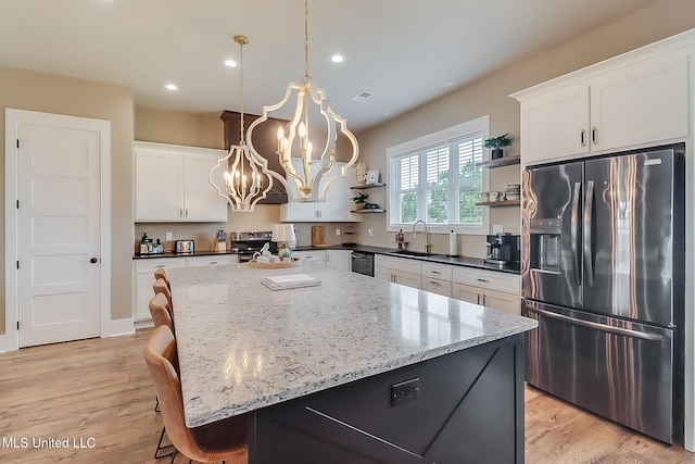 118 Sea Oaks Blvd, Long Beach, MS 39560 - kitchen featuring appliances with stainless steel finishes, open shelves, a sink, a chandelier, and white cabinetry
