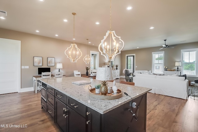 118 Sea Oaks Blvd, Long Beach, MS 39560 - kitchen with a chandelier, wood finished floors, ceiling fan, open floor plan, and dark cabinets