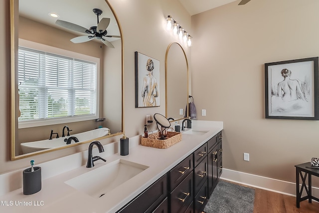 118 Sea Oaks Blvd, Long Beach, MS 39560 - full bath featuring a ceiling fan, double vanity, baseboards, wood finished floors, and a bathtub