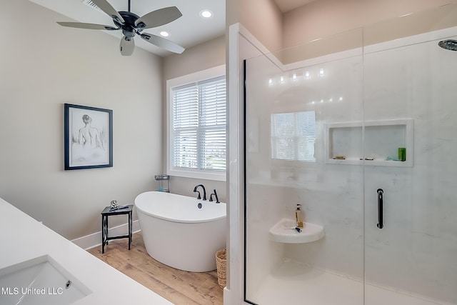 118 Sea Oaks Blvd, Long Beach, MS 39560 - full bath featuring a stall shower, wood finished floors, a freestanding bath, a ceiling fan, and baseboards