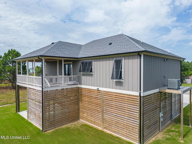 118 Sea Oaks Blvd, Long Beach, MS 39560 - rear view of house featuring a shingled roof, a lawn, central AC, and board and batten siding