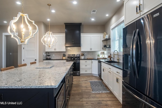 118 Sea Oaks Blvd, Long Beach, MS 39560 - kitchen featuring appliances with stainless steel finishes, a chandelier, a sink, a center island, and open shelves