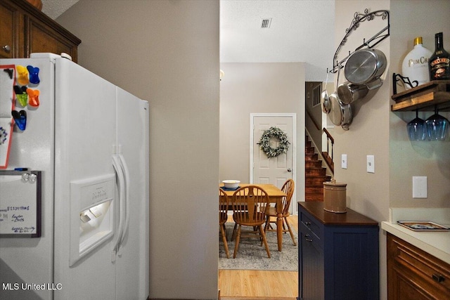 147 Lofty Pine Ln, Clinton, MS 39056 - kitchen with white fridge with ice dispenser and light wood-style flooring