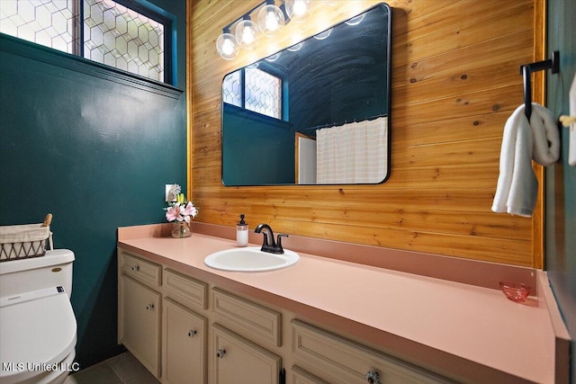 147 Lofty Pine Ln, Clinton, MS 39056 - bathroom with wooden walls, vanity, toilet, tile patterned flooring, and a shower with shower curtain