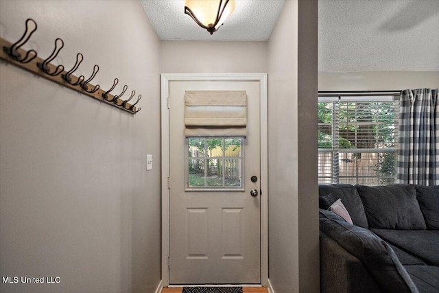 147 Lofty Pine Ln, Clinton, MS 39056 - doorway with a textured ceiling and baseboards