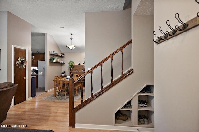147 Lofty Pine Ln, Clinton, MS 39056 - staircase with wood finished floors and a textured ceiling