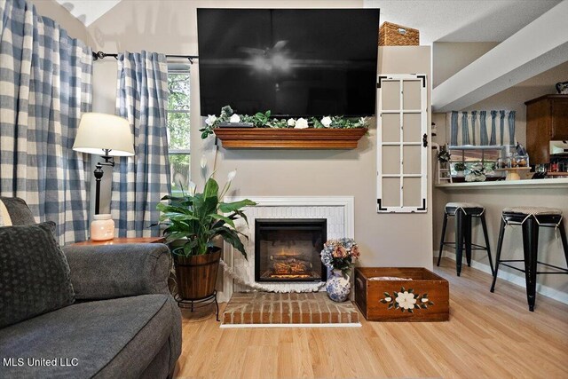 147 Lofty Pine Ln, Clinton, MS 39056 - living room with wood finished floors, a fireplace with raised hearth, and baseboards