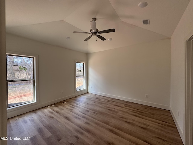 spare room featuring hardwood / wood-style flooring, ceiling fan, and lofted ceiling