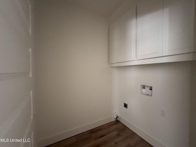 washroom with dark hardwood / wood-style flooring, hookup for a washing machine, cabinets, and hookup for an electric dryer