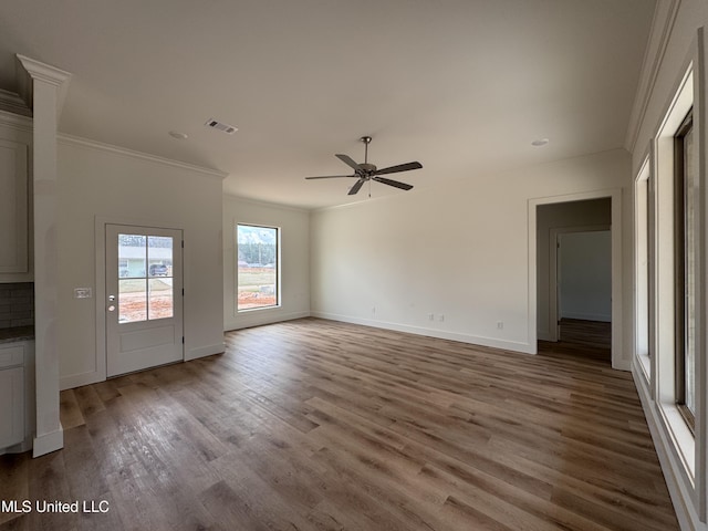 unfurnished living room featuring crown molding, ceiling fan, and light wood-type flooring