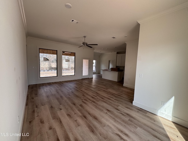 unfurnished living room featuring crown molding, ceiling fan, and light hardwood / wood-style flooring