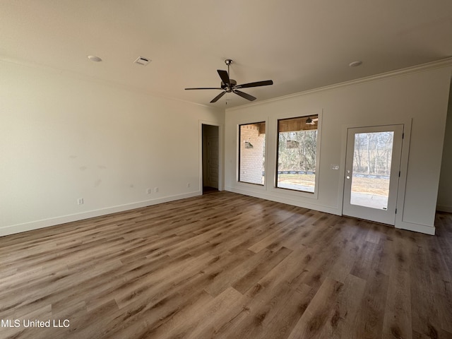 unfurnished room featuring ceiling fan, ornamental molding, and hardwood / wood-style floors