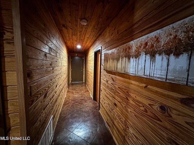 106 Crockrell Rd, Lexington, MS 39095 - corridor featuring wood ceiling, lofted ceiling, wooden walls, and dark tile patterned floors