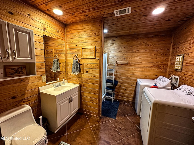 106 Crockrell Rd, Lexington, MS 39095 - bathroom featuring washer and dryer, wooden ceiling, wood walls, vanity, and tile patterned floors