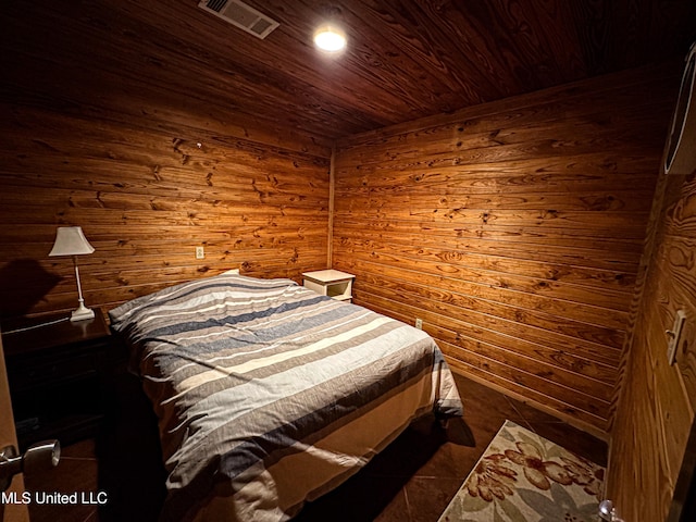 106 Crockrell Rd, Lexington, MS 39095 - unfurnished bedroom with wood walls, wooden ceiling, and dark tile patterned flooring