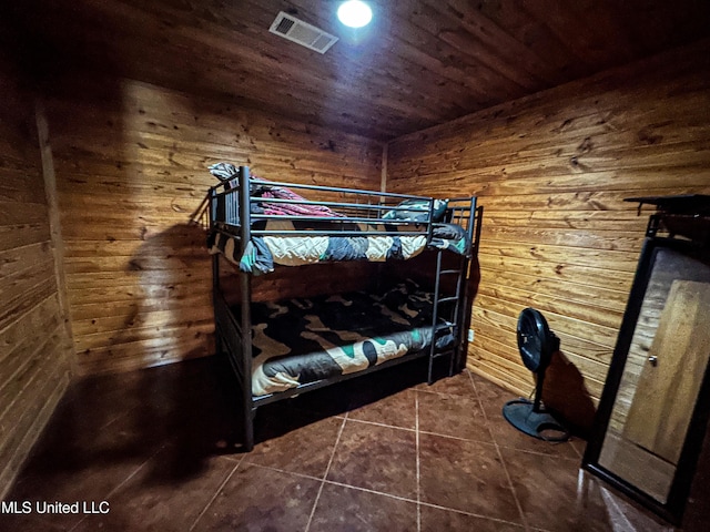 106 Crockrell Rd, Lexington, MS 39095 - unfurnished bedroom featuring dark tile patterned floors, wooden ceiling, and wooden walls