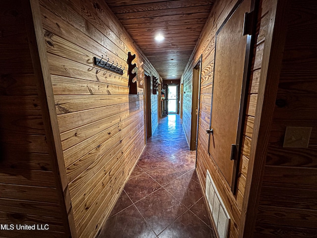 106 Crockrell Rd, Lexington, MS 39095 - hall with dark tile patterned floors, wooden ceiling, and wood walls