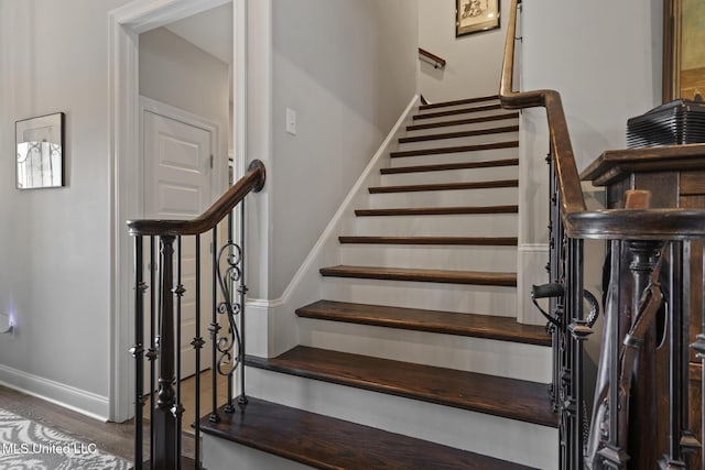 stairway featuring baseboards