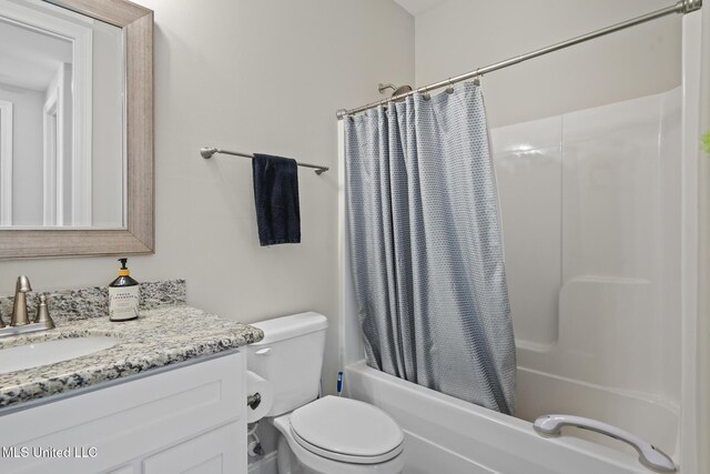 bathroom with vanity, toilet, and shower / bath combo