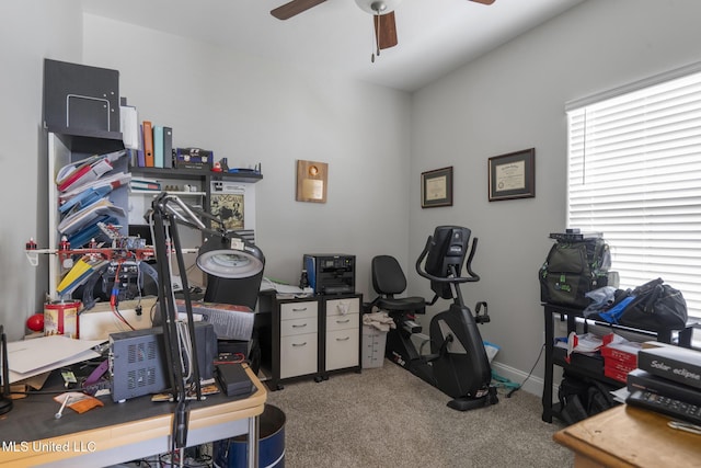 interior space featuring carpet, a ceiling fan, baseboards, and a healthy amount of sunlight