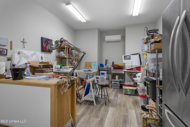 interior space with light wood-style floors and a wall mounted AC