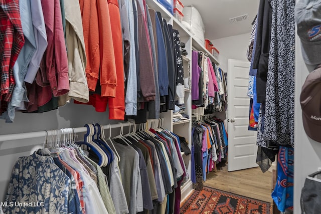 spacious closet featuring visible vents and wood finished floors