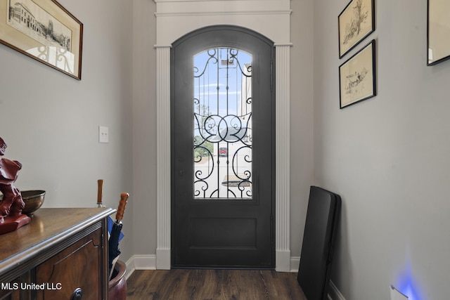 entryway with baseboards and dark wood-style flooring