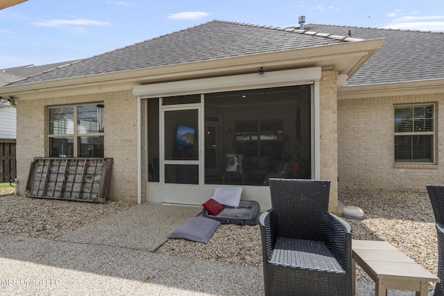 view of patio featuring a sunroom