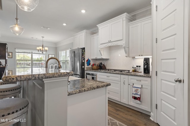 kitchen featuring dark wood finished floors, appliances with stainless steel finishes, ornamental molding, and white cabinets