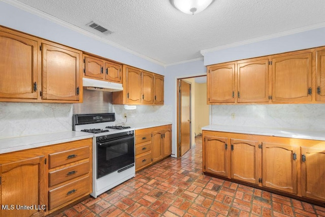 kitchen featuring a textured ceiling, tasteful backsplash, crown molding, and gas range gas stove