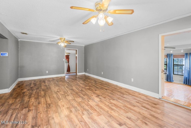 unfurnished room with ornamental molding, a textured ceiling, and hardwood / wood-style flooring