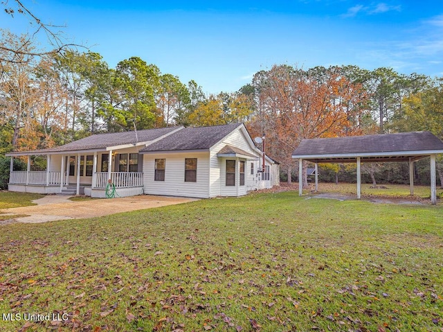 back of property with a lawn, a porch, and a carport