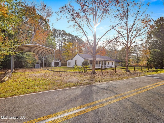 view of front of property with an outbuilding and a carport