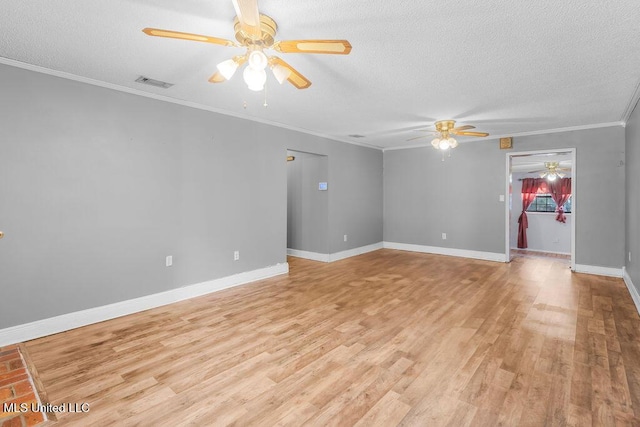 unfurnished room featuring a textured ceiling, light wood-type flooring, and ornamental molding