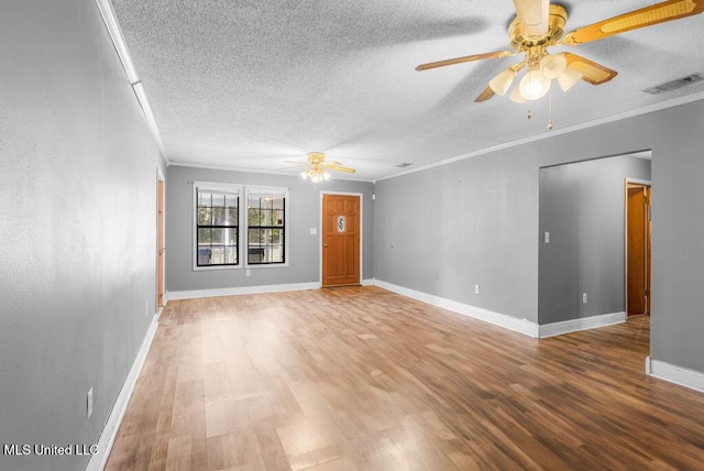 unfurnished living room with hardwood / wood-style floors, a textured ceiling, ceiling fan, and ornamental molding