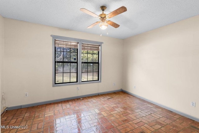 empty room featuring a textured ceiling and ceiling fan