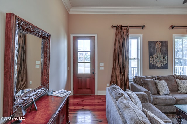 living room featuring dark wood-type flooring, crown molding, and a healthy amount of sunlight