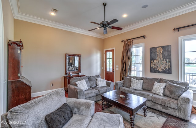 living room with hardwood / wood-style flooring, a healthy amount of sunlight, crown molding, and ceiling fan