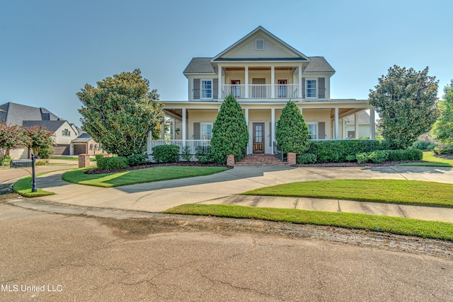 view of front of property featuring a porch and a balcony