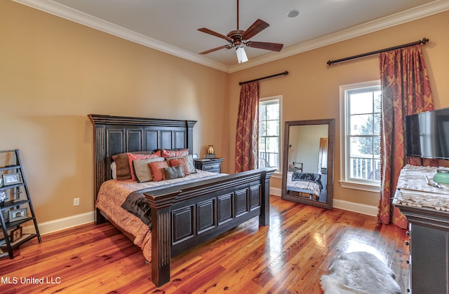 bedroom with ceiling fan, ornamental molding, and hardwood / wood-style floors